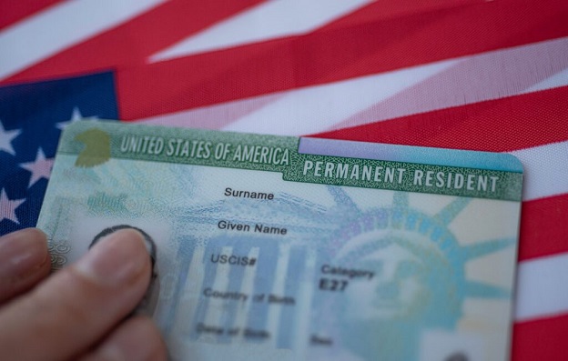 Green card against background of US flag